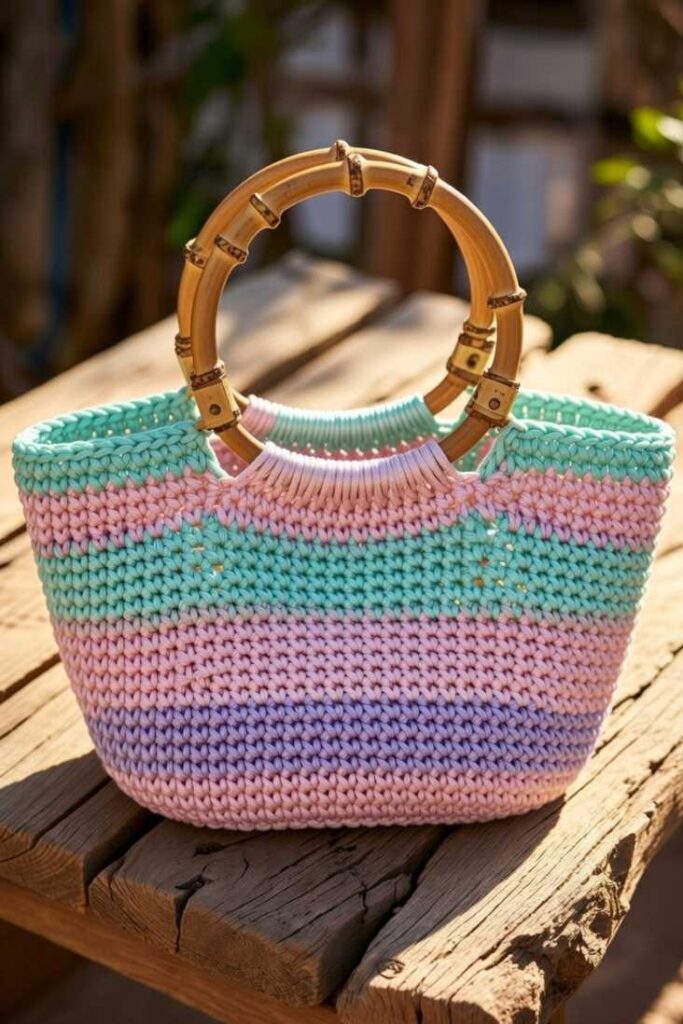 Borsa uncinetto fatta a mano intrecciata rosa verde menta viola con manici bambù rotondi texture crochet su legno luminoso