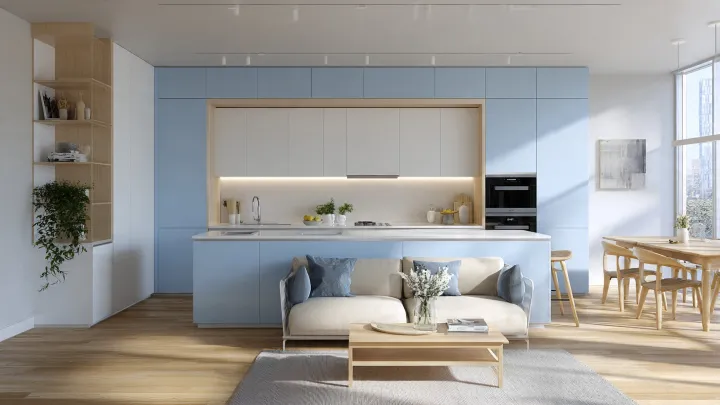 Cucina open space celeste e bianca con isola, zona living con divano integrato, pensili bianchi e parquet in rovere chiaro
