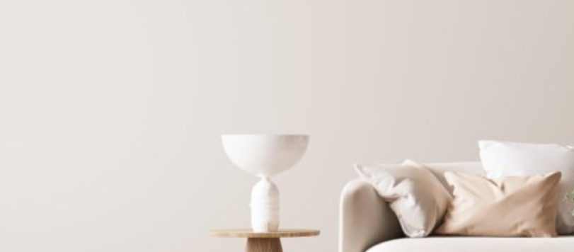 Bright modern living room mockup, beige sofa with marble coffee table and flower vase on white background, panorama, 3d rende